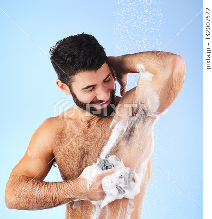 Skincare, man and foam with water, cleaning and showering for wellness and hygiene against blue studio background. Male, gentleman and washing for morning routine, daily and dermatology on backdrop 132007522