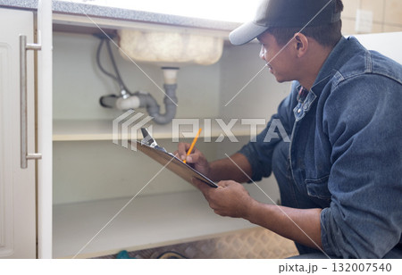 Plumber, sink maintenance document and plumbing check of a handyman in a kitchen. Water pipe installation, home repair checklist and builder in a household for building construction and inspection Plumber, sink maintenance document and plumbing check of a handyman in a kitchen. Water pipe installation, home repair checklist and builder in a household for building construction and inspection 132007540