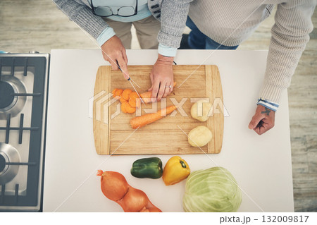 Cooking, vegetables and couple hands cook food in a kitchen for healthy, vitamins and nutritions diet in a home. Meal, overhead and people preparing fresh produce together on cutting board for dinner 132009817