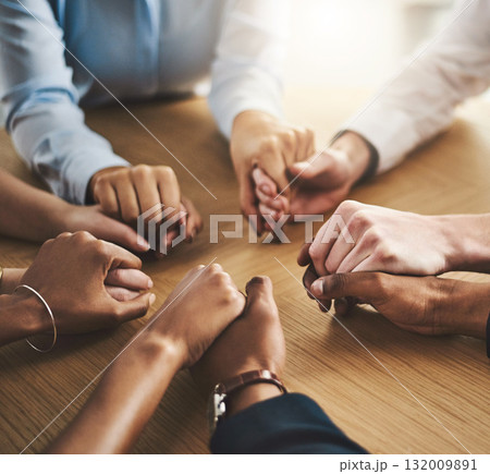 Trust circle, therapy and people holding hands by a wood table at a group counseling or psychology session. Gratitude, spiritual and friends praying together for religion, community and connection. 132009891