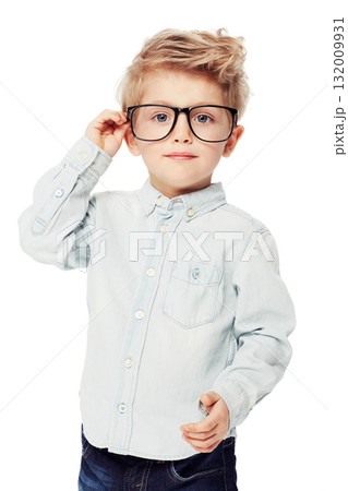 Nerd or geek, portrait of young child with glasses and in white background. Intelligent or smart, serious and isolated child adjusting his spectacles as a confident student in a studio backdrop 132009931