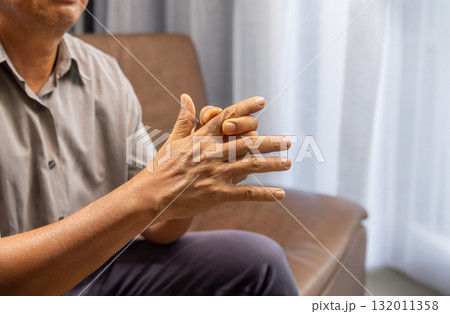 Senior man hand suffering from joint pain with gout inflammation. 132011358