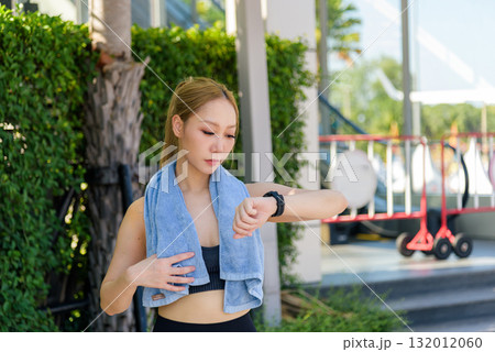 Exercise woman sport workout fit Asian people checking smartwatch outdoor, young female athlete monitoring health progress, completing energetic fitness exercise routine. 132012060