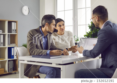 Family couple talking to bank manager, loan broker, estate agent or financial advisor Family couple talking to bank manager, loan broker, estate agent or financial advisor 132012191