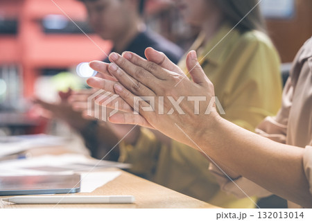 Teamwork and businesspeople in an office setting applaud for achievement or success. Collaboration, and a group of financial advisors applaud for goals, unity, or harmony. 132013014