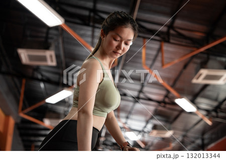 Young asian woman doing exercise and lifting dumbbells weights at sport gym. Young asian woman doing exercise and lifting dumbbells weights at sport gym. 132013344
