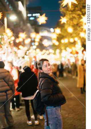 happy tourist woman stands on a German christmas market . Merry Christmas, holiday and happy New Year concept happy tourist woman stands on a German christmas market . Merry Christmas, holiday and happy New Year concept 132013387
