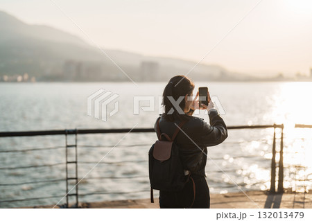 woman traveler traveling in Taiwan, female Tourist sightseeing at Tamsui Old Street in sunset. Popular landmark for tourists attractions in Taipei, Taiwan woman traveler traveling in Taiwan, female Tourist sightseeing at Tamsui Old Street in sunset. Popular landmark for tourists attractions in Taipei, Taiwan 132013479