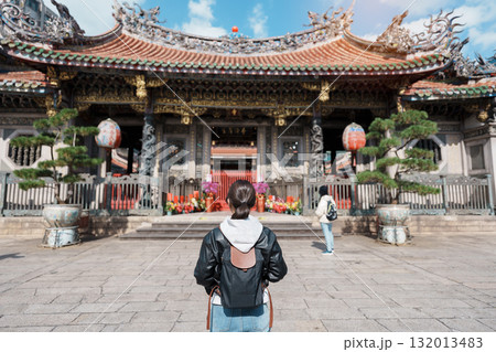 woman traveler visiting in Taiwan, female Tourist sightseeing at Longshan Temple, Chinese folk religious temple in Wanhua District, Taipei City. landmark and popular. Travel and Vacation concept 132013483