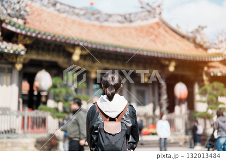 woman traveler visiting in Taiwan, female Tourist sightseeing at Longshan Temple, Chinese folk religious temple in Wanhua District, Taipei City. landmark and popular. Travel and Vacation concept woman traveler visiting in Taiwan, female Tourist sightseeing at Longshan Temple, Chinese folk religious temple in Wanhua District, Taipei City. landmark and popular. Travel and Vacation concept 132013484