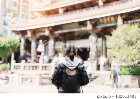 woman traveler visiting in Taiwan, female Tourist sightseeing at Longshan Temple, Chinese folk religious temple in Wanhua District, Taipei City. landmark and popular. Travel and Vacation concept woman traveler visiting in Taiwan, female Tourist sightseeing at Longshan Temple, Chinese folk religious temple in Wanhua District, Taipei City. landmark and popular. Travel and Vacation concept 132013485
