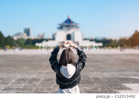 woman traveler visiting in Taiwan, female Tourist sightseeing at National Chiang Kai shek Memorial or Hall Freedom Square, Taipei City. Popular landmark and attractions. Asia Travel concept 132013492