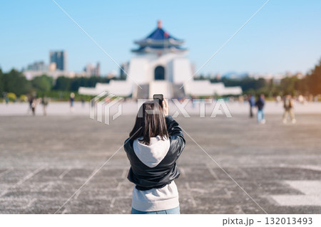 woman traveler traveling in Taiwan, female Tourist taking photo by mobile phone at National Chiang Kai shek Memorial or Hall Freedom Square, Taipei City. Popular landmark and attractions woman traveler traveling in Taiwan, female Tourist taking photo by mobile phone at National Chiang Kai shek Memorial or Hall Freedom Square, Taipei City. Popular landmark and attractions 132013493