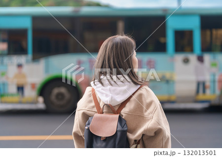woman traveler visiting in Taiwan, female Tourist with backpack sightseeing at Keelung against bus background, Popular landmarks and attractions near Taipei City. Asia travel and vacation concept 132013501