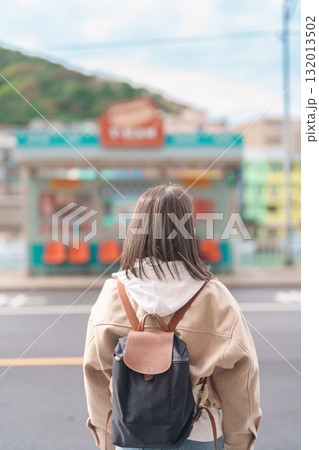 woman traveler visiting in Taiwan, female Tourist with backpack sightseeing at Keelung, Colorful Zhengbin Fishing Port. Popular landmarks and attractions near Taipei City.  Asia Travel concept 132013502