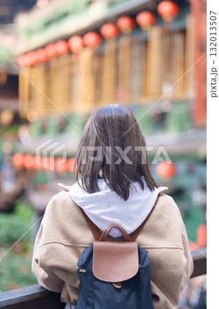 woman traveler visiting in Taiwan, female Tourist with backpack sightseeing at Jiufen Old Street village with Tea House background. Popular landmarks and attractions near Taipei City. Travel concept woman traveler visiting in Taiwan, female Tourist with backpack sightseeing at Jiufen Old Street village with Tea House background. Popular landmarks and attractions near Taipei City. Travel concept 132013507