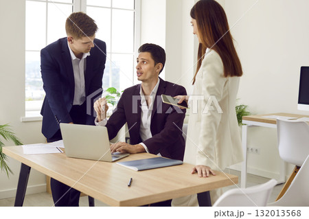 Company employees discussing a work project on a meeting in the office. Company employees discussing a work project on a meeting in the office. 132013568