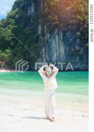 Woman tourist traveling and sightseeing in Krabi, Thailand. happy traveller enjoy on beach at koh Hong island. summer trip, destination, Southeast Asia Travel, vacation and holiday concept 132013589