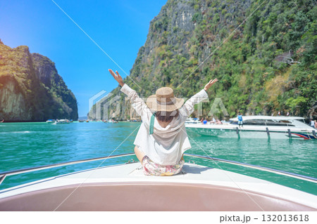 Woman tourist on boat trip, happy traveller relaxing at Pileh lagoon on Phi Phi island, Krabi, Thailand. Exotic landmark, destination Southeast Asia Travel, summer vacation and holiday concept 132013618