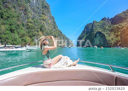 Woman tourist on boat trip, happy traveller relaxing at Pileh lagoon on Phi Phi island, Krabi, Thailand. Exotic landmark, destination Southeast Asia Travel, summer vacation and holiday concept 132013620
