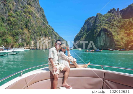 couple tourist on boat trip, happy traveller relaxing at Pileh lagoon on Phi Phi island, Krabi, Thailand. Honeymoon, tropical destination, southeast Asia Travel, summer vacation and wanderlust concept 132013621