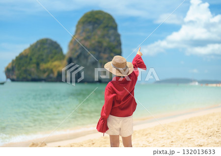 Woman tourist travel and sightseeing in Krabi, Thailand. happy traveller enjoy on beach at Phra nang Cave Beach near Railay Beach. summer trip, destination, Southeast Asia Travel and vacation concept 132013633