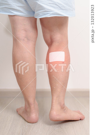 Elderly woman having Calf pain with Medicated pain relief patch plaster for concepts of Calf Muscle Strain, muscle pull, Leg Cramp, Sprain, aches, Varicose Veins, Deep Vein and world Thrombosis day Elderly woman having Calf pain with Medicated pain relief patch plaster for concepts of Calf Muscle Strain, muscle pull, Leg Cramp, Sprain, aches, Varicose Veins, Deep Vein and world Thrombosis day 132013923
