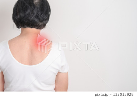 Elderly Woman having Shoulder Pain with Medicated pain relief patch plaster for Muscle Inflammation and Sprain, Myofascial ache syndrome and Fibromyalgia, Shoulder Myalgia and Scapular Tightness 132013929