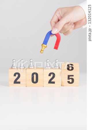 hand holding magnet and pulling man chess figure from the crowd employee with 2026 Year block. Human resource management, Recruitment, Teamwork, strategy, toxic people and leadership Concepts 132014125