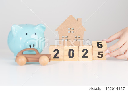 2025 end year to Happy New Year 2026 with car and Home model with coin stack. Car loan, Interest rate, real estate, house, Insurance, Financial, Repair, Tax, mortgage and Maintenance 132014137