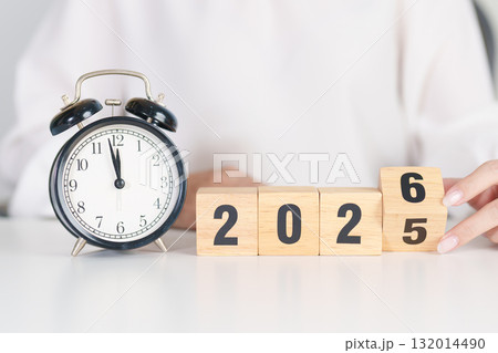 2025 end year to Happy New Year 2026 with vintage alarm clock. Christmas, New Start, Resolution, countdown, Goals, Plan, Action and Motivation Concept 132014490