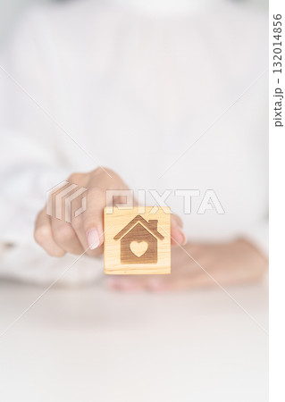 Hand Holding Home with Heart block. Property investment, House Mortgage, Real Estate tax, homeless, donation, Financial and happy family concepts Hand Holding Home with Heart block. Property investment, House Mortgage, Real Estate tax, homeless, donation, Financial and happy family concepts 132014856