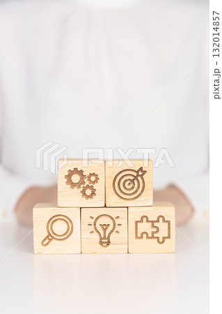 wood block with business goal, strategy, target, mission, action, objective, teamwork, research and idea concept 132014857