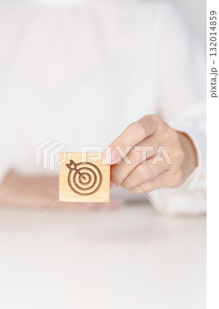 hand hold dartboard block with business goal, strategy, target, mission, action, objective, aim and success concept 132014859