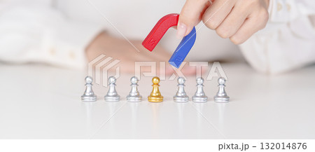 Hand use magnet pulling to golden chess pawn pieces or leader businessman stand out of crowd people of silver men. leadership, business, team, teamwork, unique and Human resource management concept 132014876