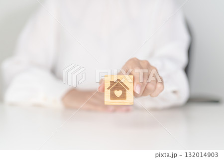 Hand Holding Home with Heart block. Property investment, House Mortgage, Real Estate tax, homeless, donation, Financial and happy family concepts 132014903