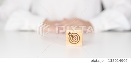 hand hold dartboard block with business goal, strategy, target, mission, action, objective, aim and success concept hand hold dartboard block with business goal, strategy, target, mission, action, objective, aim and success concept 132014905