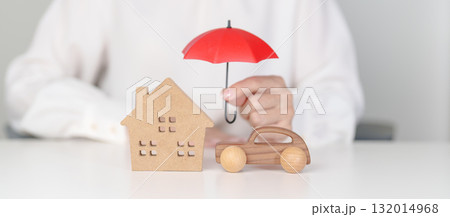 Hand hold red umbrella cover home and car model. Insurance, real estate, Home, car, loan, tax, investment, mortgage, financial, savings, protection and safety Hand hold red umbrella cover home and car model. Insurance, real estate, Home, car, loan, tax, investment, mortgage, financial, savings, protection and safety 132014968
