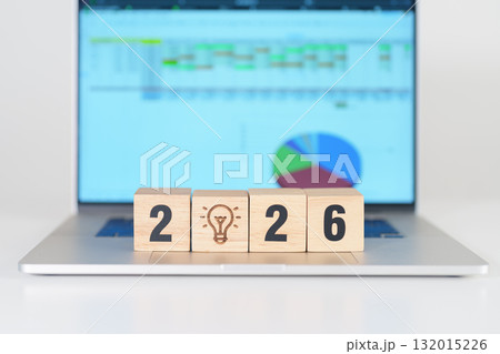 2026 Year block with lightbulb icon against computer laptop background. Business Idea, Creative, Thinking, brainstorm, Goal, Resolution, strategy, plan, Action, change and New Year start concepts 132015226
