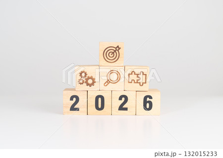Happy New Year 2026 block with wood block with business goal, strategy, target, mission, action, objective, teamwork, research, feedback and idea concept 132015233