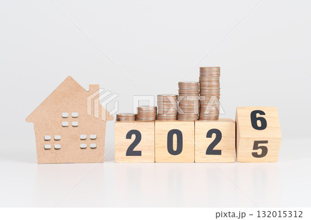 2025 end year to Happy New Year 2026 with house model and Coins stack. real estate, Home loan, tax, investment, mortgage, financial, savings and New Year Resolution concepts 132015312