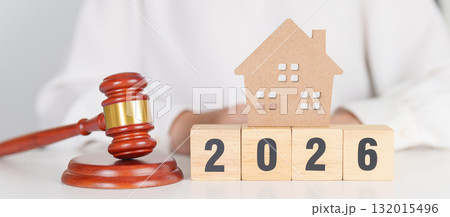 Happy New Year 2026 with small toy house model with gavel justice hammer on desk in courthouse. Real Estate Law, Home Insurance, property Tax, Auction and Bidding concepts 132015496