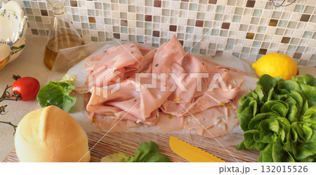Ingredients for mortadella sandwich. Sausage, lettuce, homemade mayonnaise on kitchen table. Italian cuisine, high-quality farm-raised ingredients. Ingredients for mortadella sandwich. Sausage, lettuce, homemade mayonnaise on kitchen table. Italian cuisine, high-quality farm-raised ingredients. 132015526