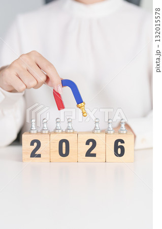 hand holding magnet and pulling man chess figure from the crowd employee with 2026 Year block. Human resource management, Recruitment, Teamwork, strategy, toxic people and leadership Concepts 132015578
