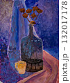 Colorful still life featuring a bottle and dried flowers on a table 132017178