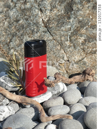 Plastic red beauty jar against backdrop of natural elements. Cosmetics and facial and hair care. Mock-up template for design. Eco-friendly products. Background, design composition. Plastic red beauty jar against backdrop of natural elements. Cosmetics and facial and hair care. Mock-up template for design. Eco-friendly products. Background, design composition. 132017358
