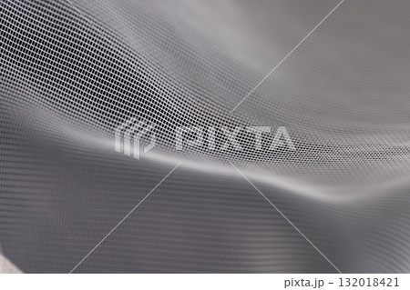fabric for making tulle or curtains close up, finely woven synthetic threads for making tulle for windows in the home fabric for making tulle or curtains close up, finely woven synthetic threads for making tulle for windows in the home 132018421
