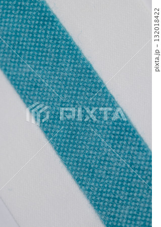 a medical band made of woven fabric with a strip of treated green liquid for wound disinfection, a long band that can be cut into pieces according to the size of the wound 132018422