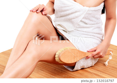 Woman is massaging skin on her legs with big brush, isolated on white background 132018797