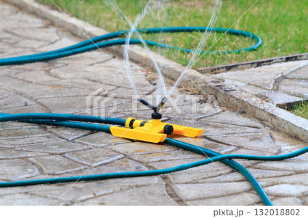 Yellow sprinkler in a garden 132018802